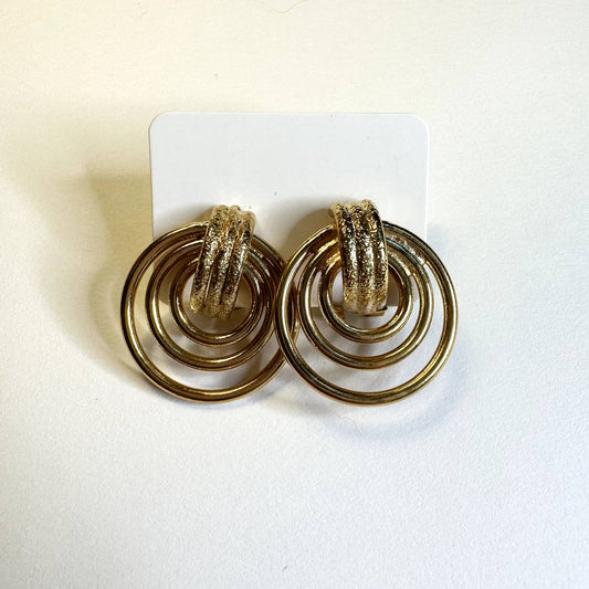 Gold colored textured smooth circular stud earrings