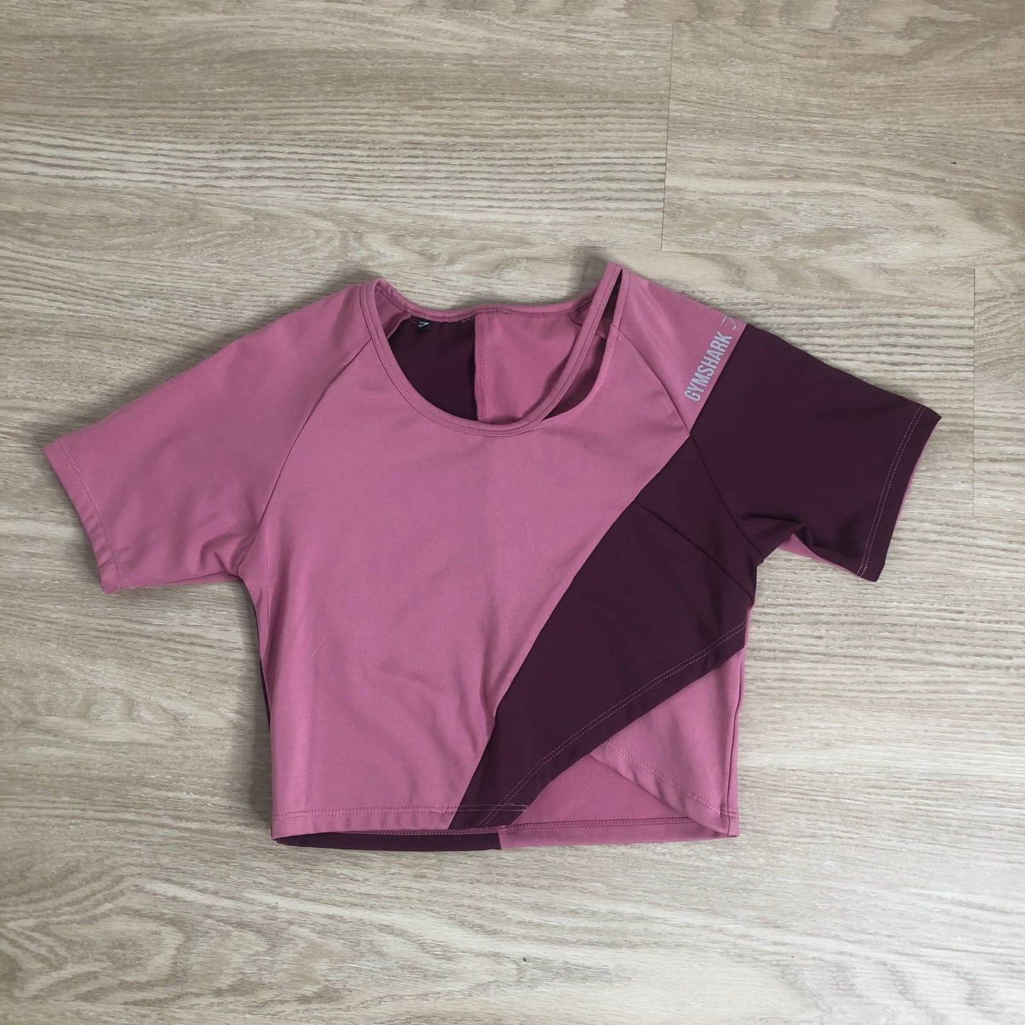 Gymshark asymmetric pink cropped color block top